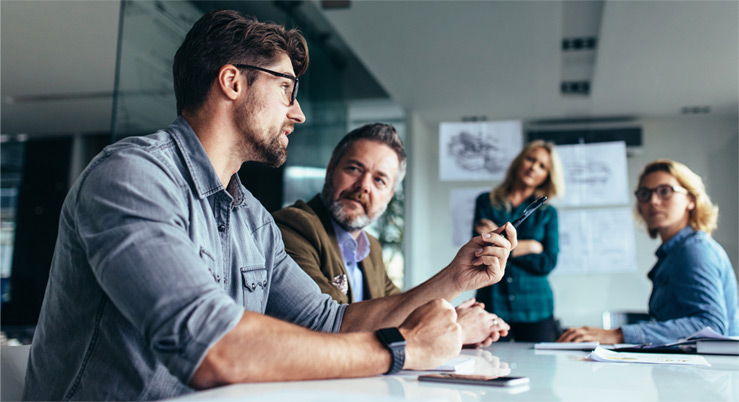 Team members at a table talking