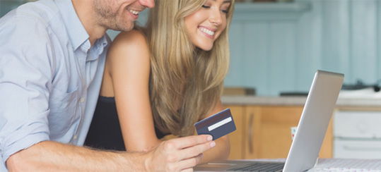 Man and Woman using a debit card online